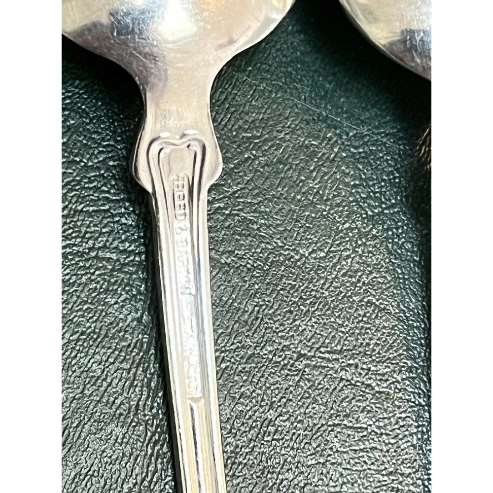 Reed & Barton Colonial Shell stainless-steel oval soup/place spoons.